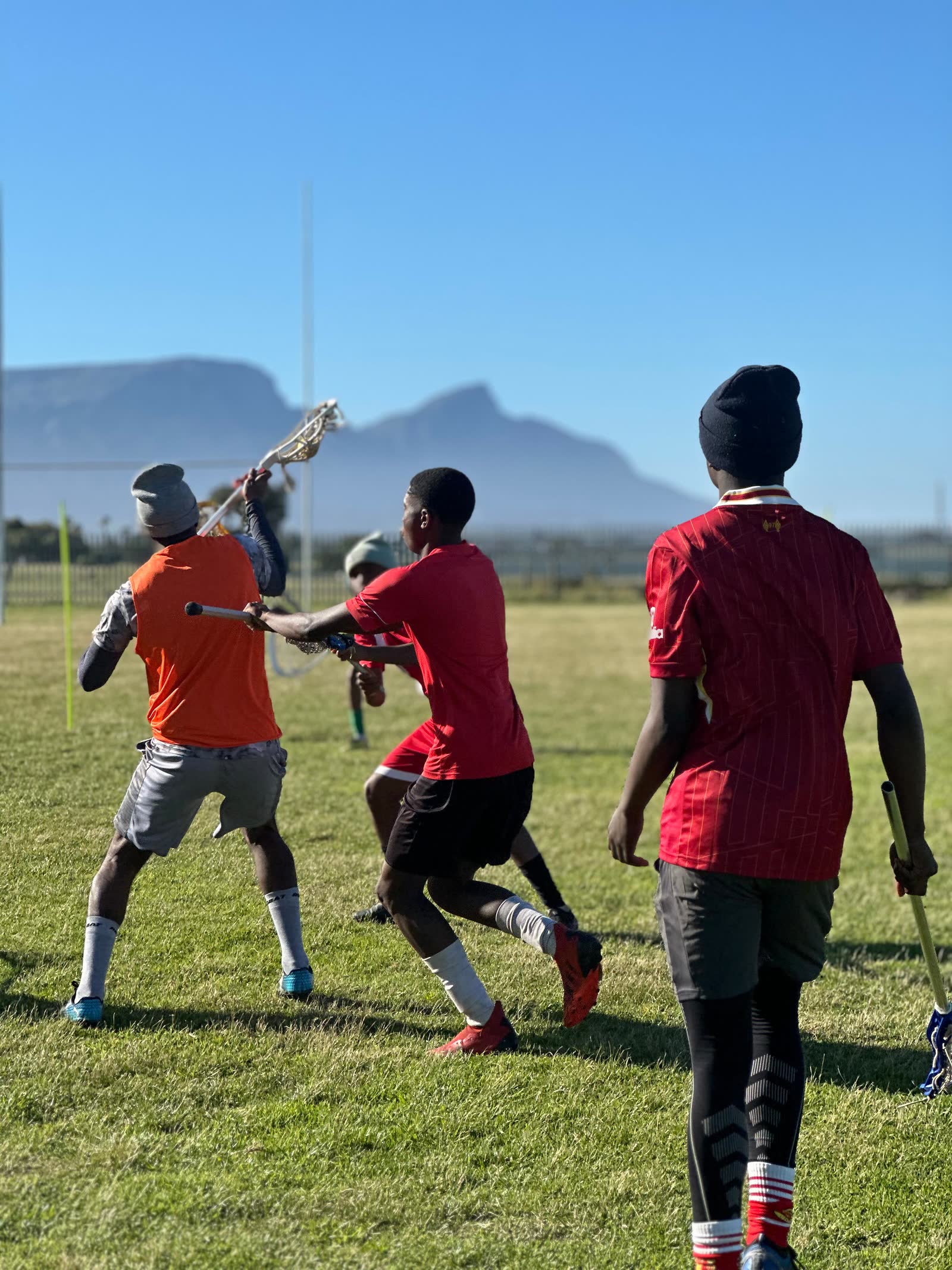 Players running with Table Mountain visible in the background